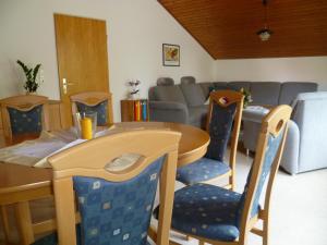 a living room with a table and chairs and a couch at Ferienwohnung Kolb in Isny im Allgäu +8 photos