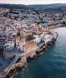 an aerial view of a city next to the water at Sea Views Penthouse in Sitges