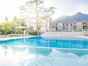 a large swimming pool in front of a building at Studio Apartment Il Pelèr in Toscolano Maderno