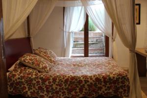 a bedroom with a bed in front of a window at Château de Prety - Maison d'Hôtes in Préty