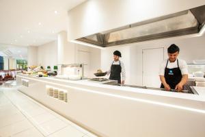 two chefs preparing food in a large kitchen at Grupotel Taurus Park in Playa de Palma +37 photos