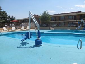 a swimming pool at a hotel with a slide in it at TravelStar Inn & Suites in Colorado Springs