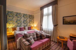מיטה או מיטות בחדר ב-Woodthorpe Hotel
