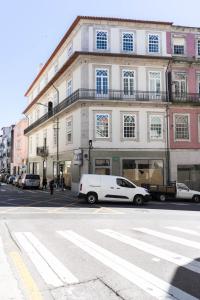 uma carrinha branca estacionada em frente a um edifício em D'Autor Apartments Alegria em Porto