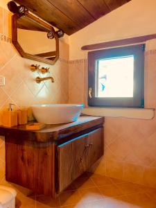 a bathroom with a sink and a window at La Casa di Elia in Arcidosso