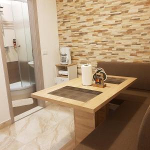 a bathroom with a wooden table with a sink at Apartments Maletic in Pula