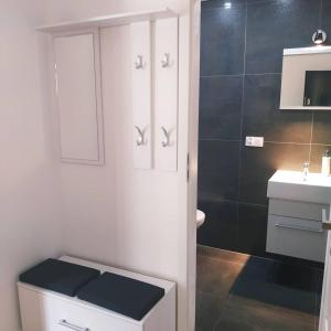 a white bathroom with a toilet and a sink at Apartament w starej kamienicy in Mrągowo