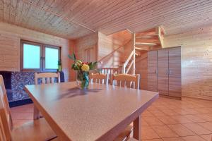a room with a table with a vase of flowers on it at DARMAT Domki Letniskowe in Stegna