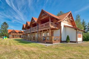 a large log home with a large yard at DARMAT Domki Letniskowe in Stegna