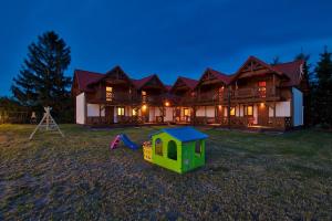 a house with a playground in front of it at DARMAT Domki Letniskowe in Stegna