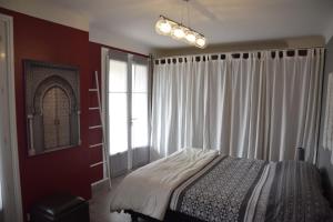 a bedroom with a bed and a window at au calme in Anglet