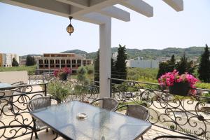a patio with a table and chairs on a balcony at Rejhan TOTTI in Ulcinj