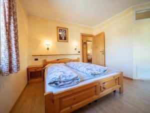 a bedroom with a bed in a room at Maison Ostaria MyHolidayLivigno in Livigno