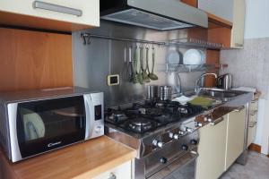 a kitchen with a stove and a microwave at Casa Isola Viscontea in Lecco +20 photos