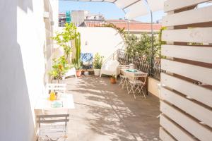 a patio with tables and chairs on a building at B&B Cannoli in Palermo