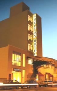 a building with cars parked in front of it at Hotel Shelton in Serra Negra