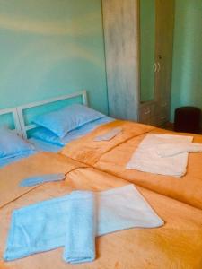 two beds in a room with towels on them at Lali in Tbilisi City