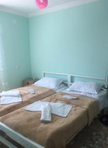 two beds in a room with towels on them at Lali in Tbilisi City