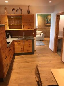 a kitchen with wooden cabinets and a sink in a room at Dopplerstubn in Agsdorf