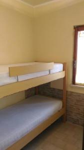 Ce dortoir comprend 2 lits superposés et une fenêtre. dans l'établissement SCALEA - RIVIERA DEI CEDRI, à Scalea