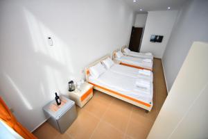 Postel nebo postele na pokoji v ubytování Orange Home Hotel