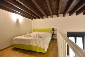 a bedroom with a bed with two towels on it at IzzHome City Center Cozy in Cagliari