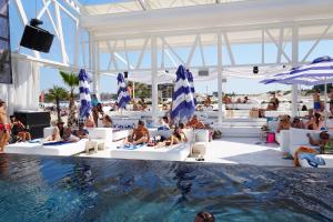 a group of people sitting in a pool at a resort at 2 Zimmer Wohnung in Sunny Beach