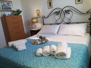 a bedroom with a bed with towels on it at Zoagli, the house of the sun in Zoagli