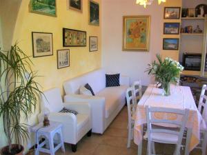 a living room with a couch and a table at Bed & Breakfast Il Rosmarino in Bosa
