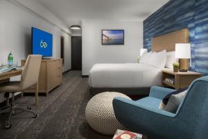 a hotel room with a bed and a desk at Hotel Caza Fisherman's Wharf in San Francisco