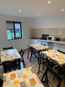a room with tables and chairs in a kitchen at Glamping Suhardul Mic in Lacu Rosu