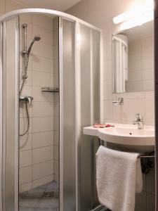 a bathroom with a shower and a sink at Sancta Elena in Šventoji +23 photos