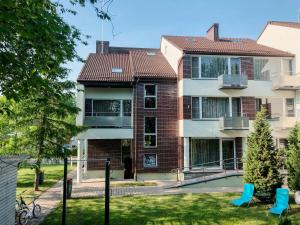 an apartment building with a playground in front of it at Sancta Elena in Šventoji