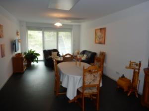 a living room with a table and chairs at Haus Stadler in Irsch