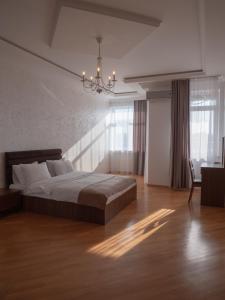 バクーにあるBoulevard Side Apartmentsのベッドとシャンデリアのある寝室 +22枚の写真