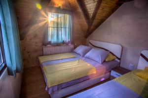 a small bedroom with a bed and a window at Apartmani Restoran Durmitor in Žabljak