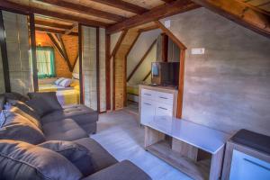 a living room with a couch and a tv at Apartmani Restoran Durmitor in Žabljak