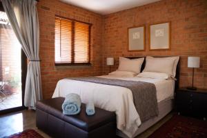 a bedroom with a bed and a brick wall at Twin Rivers Bed and Breakfast in Irene