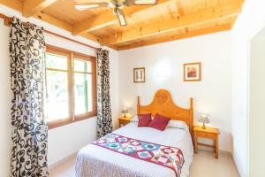 a bedroom with a bed and a window at Casa Aurora in Cala Santanyi +55 photos