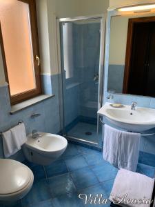 a bathroom with a toilet and a sink and a shower at Villa Acacia in Ponza