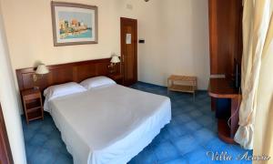 a bedroom with a white bed in a room at Villa Acacia in Ponza