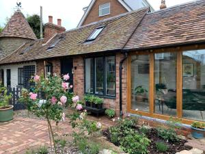 a house with a conservatory with windows and flowers at The Folly in Ludlow
