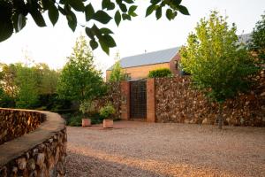 a brick building with a stone wall and a fence at Twin Rivers Bed and Breakfast in Irene