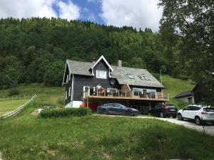 a house with two cars parked in front of it at Voss- Myrkdalen Lodge in Vossestrand