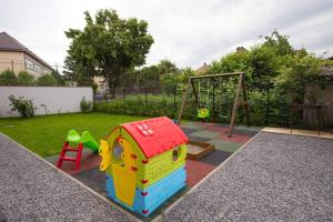 a playground with a toy house and a swing at Casa Zia in Făgăraş