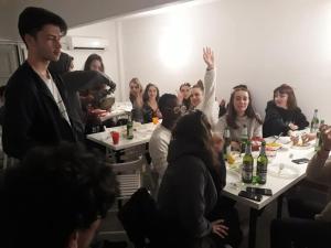 a group of people sitting at tables in a room at Sunrise Hostel & Rooms in Palermo