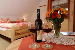 a bottle of wine and two glasses on a table at Ferienwohnungen Panoramablick in Bernau im Schwarzwald