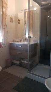 a bathroom with a glass shower and a sink at Relais La Terrazza in Palmadula +33 photos