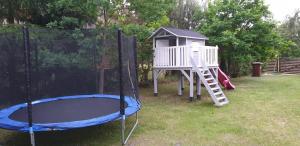 a playground with a slide and a play house at Sasinko in Sasino