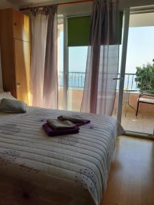 a bedroom with a bed with two towels on it at Ivan Apartment in Makarska +73 photos